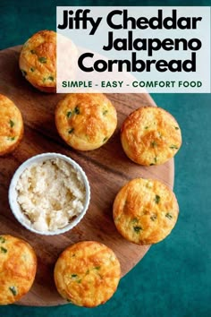 a wooden plate topped with mini muffins next to a bowl of cottage cheese