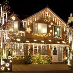 a house covered in christmas lights at night