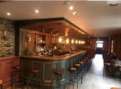 a bar with several stools in front of it