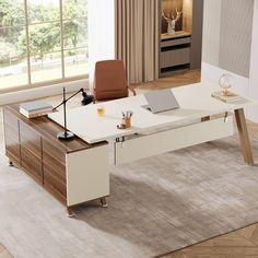 an office desk with a laptop on it in front of a window and a rug