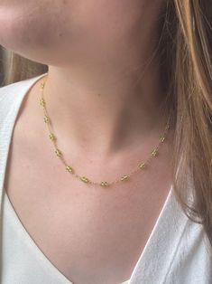 This timeless peridot necklace features pairs of micro-faceted peridot beads stationed along a shimmering chain. The lobster clasp and 2-inch extender allow for an adjustable fit. Peridot is August's birthstone, making this a meaningful gift for someone born in that month. This piece looks elegant on its own but can also be easily layered with other favorite necklaces to create your unique style. Materials: peridot, gold fill Necklace length: 16-18 inches Gift box included. Lime Green Peridot Necklace For May Birthstone, Green Jewelry With Round Beads And Adjustable Chain, Green Jewelry With Adjustable Chain And Round Beads, Lime Green Peridot Jewelry For May Birthstone, Dainty Green Beaded Chain Jewelry, Peridot Faceted Jewelry For May Birthstone, Peridot Faceted Beads Jewelry Gift, Faceted Peridot Jewelry For May Birthstone, Green Birthstone Round Bead Jewelry