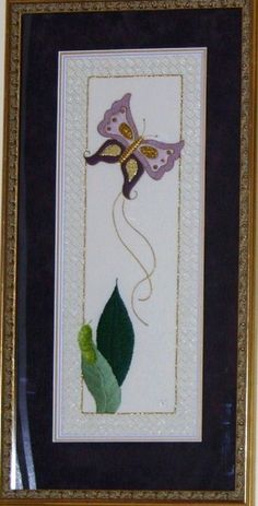 a framed picture with a purple flower and green leaf on the bottom half of it