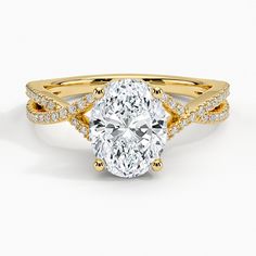 a yellow gold engagement ring with an oval cut diamond in the center