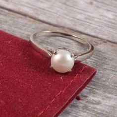 "This Sterling Silver Ring features an Elegant Art With Natural Pearl Gemstone. The cavity is made from genuine solid 925 sterling silver and stamped as S925. This Jewelry is Lead free and Rhodium plated to resist scratches and tarnish. ITEM DESCRIPTION Item Code: JARG160 Metal: 925/92.5 Sterling Silver Gemstone: Genuine Natural Cultured Pearl Gemstone Shape: Round Gemstone Size: 7 MM Round Ring Length: 7 MM Ring width: 7 MM Weight: 2.17 gm approx **Keep the jewelry away from direct heat, water, Silver Pearl Ring For Women, Silver Birthstone Ring In 14k White Gold For Gift, Timeless Silver Pearl Ring In Sterling Silver, Timeless Sterling Silver Pearl Ring In Silver, Classic Silver Pearl Ring With Polished Finish, Timeless Pearl Ring In White Gold Sterling Silver, Timeless Silver Sterling Silver Pearl Ring, Timeless White Gold Pearl Ring In Sterling Silver, Timeless White Gold Sterling Silver Pearl Ring