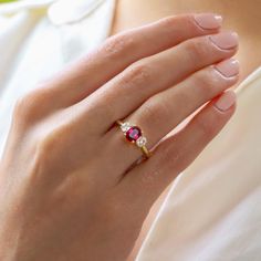 Ruby Engagement Ring, Yellow Gold Ring, Oval Cut Diamond Trilogy Ring, Wedding Ring, Promise Ring, Gemstone Jewelry, Rings, Art Deco Ring ♠ Stone Details ➵ 1.15 Ct Approx. Total Oval Cut Ruby ➵ Side Stone Weight: 0.30Ct Round Cut Simulated Diamond ➵ Band Width: 2.0mm ➵ Gemstone: Ruby ➵ Side Stone: Simulated Diamond ➵ Stone Color (Red) ➵ Stone Luster: Excellent ➵ Stone Clarity: VVS1 ➵ Stone Make: High Quality ➵ Center Stone Shape: Oval Cut Ruby ➵ Metal Change(10k/14k/18k White/Yellow/Rose Gold) ➵ Ruby Trilogy Ring, Three Stone Open Ring For Anniversary, Oval Ruby Jewelry With Brilliant Cut For Weddings, Fine Jewelry Three Stone Rings For Proposal, Oval Ruby Ring With Brilliant Cut For Gift, Oval Ruby Ring With Brilliant Cut As Gift, Oval Ruby Ring For Promise, Three Stone Round Cut Topaz Wedding Ring, Classic Three Stone Ruby Promise Ring