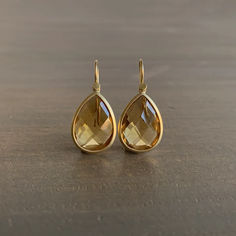 Golden honey tones flow and flash with every turn of these breathtaking citrine drops. 

Citrines, 17.75 carats total weight 
18k yellow gold 
Earrings measure 1/2" at the widest and hang 13/16" from the ear 
Each earring weighs 2.8g Citrine Drop Earrings, Golden Honey, Citrine Earrings, Yellow Gold Earrings, Newport Ri, American Art, Citrine, Jewelry Art, Gold Earrings