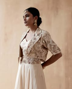 Editor's Note Presenting a sophisticated ivory jacket adorned with intricate floral thread embroidery and diverse embellishments, beautifully paired with a blouse and organza sharara, creating a timeless and elegant ensemble, perfect for special occasions. Fabric: Dupion silk & organza Color: Ivory Components: Sharara, jacket and blouse Occasion: Festive Note: Product colour may slightly vary due to photographic lighting sources Care: Dry clean only About the Designer Aman Takyar, renowned for h Sharara Jacket, Organza Sharara, Floral Thread Embroidery, Organza Jacket, White Party Outfit, Celebrity Style Dresses, Embroidery Jacket, Fashionable Saree Blouse Designs, Embroidery On Kurtis