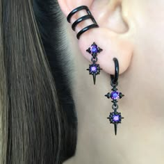 Our Classic Double North Star earrings are now available as a hoop.   Earrings are made of 316 Stainless steel, and set with Black ,Blue and  Purple  CZ. Hoops are perfect for both men and women.   Sold as Pair Total height: 40 mm Hoop Inner diameter: 10.5 mm Post Gauge: 22G (regular piercing) *RETURNS / REFUNDS * -If you would like to return you purchase , please contact us within 7 days of receiving your package and we will accept the return.Return will only be made to the product, and not the shipping cost.  -Buyer is  responsible for the return shipping costs . -All jewelry must be returned unworn and in their original condition . *LOST MAIL* Once the package is marked as DELIVERED by the post office, we are not responsible for misplaced or stolen packages. *MAIL THEFT* If parcel is st Edgy Pierced Hoop Earrings As Gift, Punk Style Star-shaped Metal Earrings, Punk Style Small Hoop Pierced Jewelry, Edgy Small Hoop Earrings As Gift, Punk Hoop Earrings As Gift, Gothic Pierced Hoop Earrings As Gift, Gothic Hoop Earrings Gift, Gothic Dangle Hoop Earrings, Punk Style Small Hoop Jewelry Gift