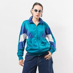 "Vintage 90's multi color block track jacket with a front zip - brand Active - 2 side pockets - unisex - materials: polyester SIZE size from label: L (men's size) best fits women: XL (can be worn by a person in a smaller size as an oversize fit) MEASUREMENTS bust: 45 inches (114 cm) length: 29 inches (73 cm) sleeve length from the armpit: 22 inches (56 cm) The model is 5'9\" (174 cm), measures 35-27-38 (90-67-95 cm) and wears size M CONDITION: The tracksuit top in great condition. Washed, ready Green Color Block Track Jacket For Sports, Green Color Block Track Jacket For Streetwear, Green Color Block Track Jacket For Winter, Sporty Green Color Block Track Jacket, Green Color Block Windbreaker For Streetwear, Retro Green Track Jacket For Streetwear, 90s Style Green Track Jacket For Sports, 90s Color Block Track Jacket For Winter, Retro Color Block Track Jacket For Sports