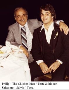 two men sitting next to each other at a table