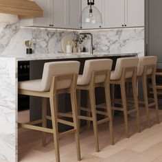 a kitchen with marble counter tops and bar stools