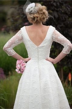 a woman in a wedding dress with her back to the camera