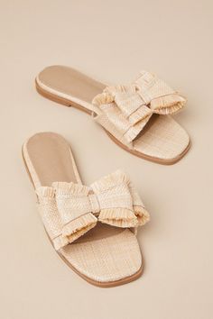 Step into the Castiel Natural Woven Raffia Bow Slide Sandals for an effortlessly chic day strolling through the sunshine! These beachy sandals have a woven raffia construction that shape a squared footbed and a wide vamp strap adorned with a chic, oversized bow-inspired detail. Simple slide-on design makes for easy styling on those leisurely vacay days! 0. 5" rubber heel. Lightly cushioned insole. Rubber sole has nonskid markings. Man made materials. Imported. Lulus | Castiel Natural Woven Raffi Woven Sandals For Beach Vacation, Summer Woven Sandals For Vacation, Summer Woven Sandals For Beach Season, Woven Sandals For Summer Outings In Spring, Chic Beach Sandals For Summer, Feminine Flat Heel Sandals For Summer, Feminine Flat Heel Summer Sandals, Chic Summer Beach Sandals, Elegant Sandals For Summer Vacation