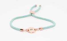 Discover the charm of our personalised initial bracelet, a delightful combination of a hand-stamped rose gold plated disc and an adjustable aqua/turquoise -coloured cord.  Featuring a hand-stamped initial on a plated metal disc, this custom bracelet embodies the essence of handmade jewelry.  Whether you're looking for a birthday gift for her or a special treat for yourself, this personalized bracelet is destined to be well received and is one of our most popular bracelets in our shop. Its adjust Initial Bracelet Silver, Gifts For Teenage Girls, Initial Bracelet Gold, Rose Gold Initial, Popular Bracelets, Monogram Bracelet, Bracelet In Silver, Cord Bracelet