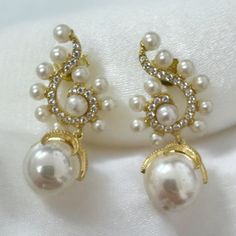 Ideal for those who love statement jewellery makes these baroque pearl Poseidon earrings the finishing touch for any special occasion outfit. The swirl tops are adorned with cubic zirconia and edged with small pearls with suspended baroque pearls, which change in the light with their iridescence. Pearls are a forever classic. They're the epitome of traditional style, an accessory that will never let you down. This timeless gemstone will take you to every significant event of your life. Materials Exquisite Evening Pearl Earrings With Cubic Zirconia, Exquisite Pearl Earrings With Cubic Zirconia For Evening, Exquisite Cubic Zirconia Pearl Earrings For Evening, Luxury Pearl Embellished Earrings For Evening, Elegant Pearl Pendant Earrings For Celebration, Elegant Baroque Pearl Earrings For Party, Glamorous Pearl Earrings For Formal Occasions, Exquisite Bridal Earrings With Elegant Design For Evening, Glamorous Pearl White Earrings For Formal Occasions