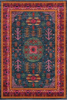 a colorful rug with an intricate design on the front and back side, in blue