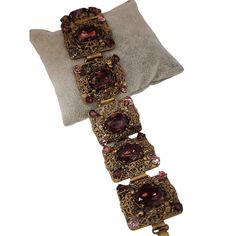 "Vintage Czech Glass & Filigree Elaborate Panel Bracelet (A4360) Size: 1.25\" x 8\" Condition: Very good vintage Era: Circa 1960s Signed: None Details: Beautiful, very elaborate panels, highly detailed bracelet. A few small stones look like they have a colored coating on them that is coming off. Please look at all the photos, as they are part of the description. I try my best to point out any flaws. Also please remember this is a preloved piece and may show signs of light wear, marks, scratches, etc. I will be posting a lot more jewelry, Keep checking back." Vintage Jeweled Jewelry For Evening, Vintage Formal Bracelet With Intricate Design, Formal Vintage Bracelet With Intricate Design, Vintage Jeweled Bracelets For Wedding, Victorian Jeweled Bracelets For Formal Occasions, Victorian Bracelets With 17 Jewels For Evening, Vintage Handmade Bracelet For Formal Occasions, Vintage Handmade Bracelets For Formal Occasions, Antique Jeweled Bracelets For Party