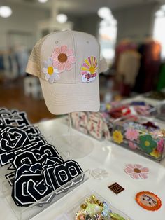 Score a custom hat for $39! The hat color and patches will be a total mystery! We have a variety of hat colors including black, white, red, yellow, orange, blue, green, pink, and more. Our patches could be your initial, athletics, boho, western, flowers, travel, etc. All hats are adult size and will include 3 patches. ALL SALES ARE FINAL. Are you ready for the mystery? Below are some examples of hats made in store. Want to make your own? Visit us in store for the Hat Making Experience! Retro White Hat With Logo Patch, White Retro Hat With Logo Patch, Retro Snapback Hat With Curved Bill For Spring, Retro Curved Bill Hats For Spring, Spring Baseball Cap With Logo Patch And Curved Brim, One Size Snapback Hats With Patches, Adjustable White Hat With Patches, White Patches Hat For Summer, Vintage Curved Bill Snapback Hat For Spring