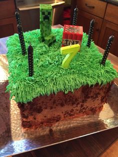 a cake with green frosting and decorations on it