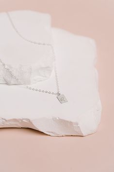 A tiny rectangle tag charm hangs beautifully from our sparkly cable chain.Classic, minimalist & dainty. Created in 14k gold filled or sterling silver. Hand stamped with 1 initial OR 1 symbol per charm. We can only stamp on the front of the charm. The tag charm measures 10mm x 6mm. Add as many tags as you need. Add additional tags as your family grows! Spring ring clasp.Handcrafted in our San Clemente studio. Need more than 3 tags, you can add them right above the add to cart button. 1 Symbol, Tiny Tags, San Clemente, Personalized Tags, Personalized Necklace, Rope Chain, 14kt Gold, Tag Necklace, Beaded Chain