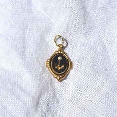 This charm is made of an 10x8mm carved glass cab that was produced in Germany in the 1970s. The charm has been hand set by me in a raw brass setting. The overall size of the charm including the setting is 18mm tall (including loop) and 12mm wide. The charm comes with a jump ring for threading on your favorite necklace Vintage Enamel Oval Pendant Jewelry, Vintage Enamel Jewelry With Vintage Charm, Vintage Gold Handmade Charms, Vintage Handmade Gold Charms, Handmade Vintage Gold Charms, Gold Enamel Vintage Charm, Gold Enamel Charms With Vintage Design, Antique Gold Jewelry With Vintage Charm Oval Pendant, Antique Enamel Charms Jewelry