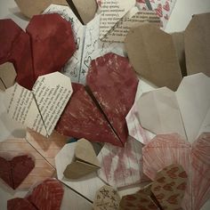 many different pieces of paper with hearts cut out of them on top of each other