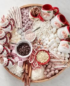 a platter filled with candy, marshmallows and santa clause figurines