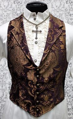 Note: These vests are very fitted. Check the size measurements below very carefully to find the size that will fit you best. A Victorian gentleman's vest with class. Great for formal occasions, can be worn under a suit jacket or by itself. Made in rich purple and gold tapestry fabric with black satin lining and back. This vest has a very flattering tapered fit and ties in back with satin belting so it can be made tighter in the waist. Fastens in front with six metal buttons. A notched collar add Aristocrat Vest, Steampunk Men, Victorian Gentleman, Gold Tapestry, Steampunk Clothing, Dieselpunk, Steampunk Fashion, Goth Fashion, Gothic Fashion