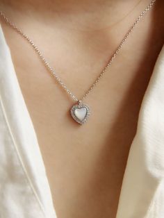 "* CZ White Shell Heart Pendant Necklace * This necklace is made from sterling silver, high quality CZ diamond and features a hear-shaped pendant with a white shell insert attached to a fine chain. This minimalist-style necklace which looks great both combined with other chain necklace or on its own. This necklace is truly timeless and suitable for any everyday wear. You will love to wear yourself or give as gift.  The perfect gift for an anniversary, birthday, engagement, a graduation, bridesmaid gift, Christmas, or any other occasion. Material: 925 Sterling Silver   Finish: 925 Sterling Silver  Chain: 16\"  Pendant Size: 10mm x 10mm  Package: All jewelry will arrive tastefully packaged making it a perfect gift.  Category: Shell Pendant, Seashell Necklace, Shell Necklace, Natural Shell, S White Clavicle Chain Heart Necklace For Anniversary, White Heart Clavicle Chain Necklace For Anniversary, Anniversary White Heart Clavicle Necklace, White Heart Necklace With Clavicle Chain As Gift, White Heart Clavicle Chain Necklace As Gift, White Heart Pendant Clavicle Chain Jewelry, White Heart Pendant Necklace With Clavicle Chain, White Heart Pendant Clavicle Chain, White Sterling Silver Heart Necklace With Clavicle Chain