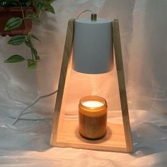 a wooden stand with a lit candle on it