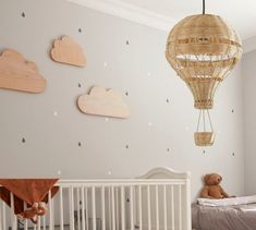 a baby's room with a crib, bed and wall decorations