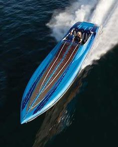 a blue speed boat speeding across the water