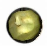 an apple is cut in half and sitting on a white surface with a black circle around it