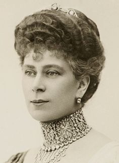 an old black and white photo of a woman wearing a tiara with pearls on her neck