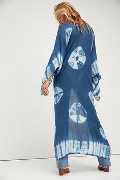 In a super soft fabric and tie dye pattern this oversized maxi kimono features statement cutout detailing under the arms. Blue Breezy Flowy Cover-up, Blue Flowy Breezy Cover-up, Bohemian Rayon Cover-up For Vacation, Flowy Unlined Cover-up For Vacation, Flowy Long Cover-up For Vacation, Long Flowy Cover-up For Vacation, Bohemian Lightweight Cover-up For Beach Party, Blue Maxi Dress For Summer Loungewear, Summer Vacation Wrap Maxi Dress