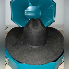 Schneiders Cowboy Hat Showman Western 7 1/8 Long Oval. Black. And Hat Carrier Is Included. Black Brimmed Western Hats, Western Black Fedora Hat, Black Western Brimmed Hat, Western Style Black Fedora Hat, Black Western Style Brimmed Hats, Black Brimmed Felt Hat For Country Events, Black Western Felt Hat With Curved Brim, Black Curved Brim Hat Bands For Rodeo, Black Fedora Hat For Ranch