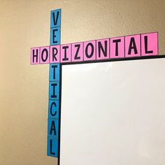 a cross made out of scrabble tiles with the words horizontal and vertical on it