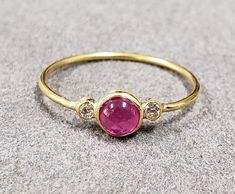 1. Diamond & Ruby 18k Gold Ring 2. Made to Order 3. Gemstone - Ruby, Diamond  4. Jewelry Type - Gold Ring 5. Total Weight - 1.040 Gram Approx. 6. Diamond Weight - 0.05 Carats  7. Ruby Weight - 0.55 Carats 8. Gold Weight - 0.920 Grams Approx.  9. Ruby Size - 4 MM 10. Gold Purity - 18k 11. Band Size - 1 MM 12. Handmade Items 13. AAA Quality Ring 14. Stackable Ring 15. 1 Quantity Available 16. Ready to dispatch in 1 - 2 days.  Pictures are taken under natural and day light. Ruby Cabochon Round Jewelry, Ruby Ring In Yellow Gold With Bezel Setting, Yellow Gold Ruby Ring With Bezel Setting, Luxury Ruby Ring With Round Stone Setting, Bezel Set Diamond Gemstones, Red Round Stone Jewelry With Bezel Setting, Gold Ruby Ring With Gemstone Accents, Round Ruby Gemstones In Yellow Gold, Round Diamond Gemstones With Bezel Setting