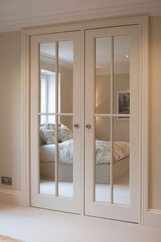 an image of a bedroom with mirrored doors