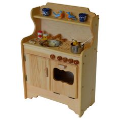 a wooden toy stove with two pots and pans on it's top shelf