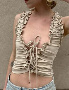 Fitted Beige Ruched Top, Beige Ruched Stretch Top, Fitted Ruched Top With Ruffled Straps, Stretch Top With Ruffled Straps And Details, Sleeveless Ruched Beige Tops, Fitted Solid Tops With Ruffles, Beige Sleeveless Ruched Top, Fitted Solid Color Tops With Ruffles, Fitted Beige Ruffled Tops