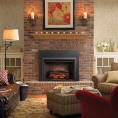 a living room filled with furniture and a fire place under a painting on the wall