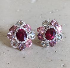 A Statement Earring handcrafted in Rose Gold Plated over Sterling Silver features a center Garnet embellished with Multi-color Spinel and Tourmaline and Halo Diamonds. A stunning, jaw-dropping stud earrings that makes a commanding statement earrings.(e-c-63) Earring measure 9mm x 20mm *LIKE* us on Facebook http://www.facebook.com/Belesas to get 10%off coupon code, *FOLLOW* us on Twitter https://twitter.com/#!/Belesas to get more exclusive coupon codes *All item are ready to ship! Free shipping o Pink Gemstones In Fine Jewelry Style, Luxury Pink Multi-stone Earrings, Pink Multi-stone Earrings Fine Jewelry, Pink Multi-stone Earrings In Fine Jewelry Style, Pink Multi-stone Earrings For Anniversary, Pink Multi-stone Earrings For Gift, Multicolor Gemstone Accented Earrings For Wedding, Multicolor Gemstone Accent Earrings For Wedding, Pink Oval Ruby Earrings