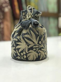 Complete your traditional looks with this lovely potli bag on your wrist, which is trendy yet compact enough to carry your essentials in style. This potli bag will be a pretty inclusion in your accessory collection and perfect for taking in a party.This bag can also be used as a wedding favour bag. It is perfect as a gift for weddings, bridal showers, baby showers, wedding receptions - excellent to fill with candy, dry fruits, sweets, herbs, soap, something remarkable for your guests that no one Traditional Bags With Gold Embroidery For Gifts, Traditional Bag With Gold Embroidery, Traditional Gold Embroidered Potli Pouch Bag, Traditional Potli Bag With Gold Embroidery, Festive Embroidered Pouch Bag, Floral Embroidered Pouch Shoulder Bag For Gift, Floral Embroidered Pouch Shoulder Bag As Gift, Floral Embroidery Pouch Shoulder Bag As Gift, Floral Embroidered Pouch Shoulder Bag