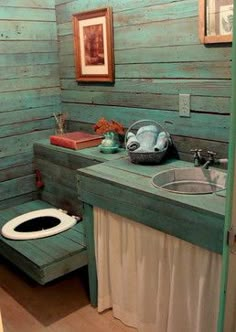 a bathroom with a toilet, sink and wooden walls in the corner next to a doorway