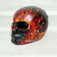 a skull with flames painted on it's face is shown in front of a white background