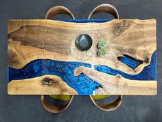 a wooden table with blue and green designs on it's sides, top view