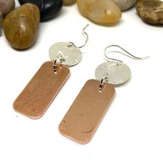 If you are looking to add a special touch to your outfit, or you need a unique gift, these handmade copper and sterling silver earrings would be perfect. Because of their sleek design, they are great to be used at work or to go out with friends. These earrings are perfect to indulge yourself or as a gift to give joy to someone else. The earring drop length is 2 inches and the width is 0.5 inches * Similar design with patina: https://www.etsy.com/listing/921888435 * To check other designs in the shop go to https://www.etsy.com/shop/LittleYellowRoomShop * Packing: Your order will be packed and ready to be presented as a gift. If you are sending it to someone else I will include a gift note from you. Just let me know what you'd like the note to say. * Photography: I do my best to photograph e Hammered Copper Earrings For Gift, Minimalist Silver Copper Earrings, Minimalist Copper Drop Earrings, Minimalist Electroformed Earrings For Gift, Silver Electroformed Earrings, Electroformed Rose Gold Dangle Earrings, Electroformed Dangle Earrings For Gifts, Unique Nickel-free Rose Gold Earrings, Artisan Nickel-free Rose Gold Earrings