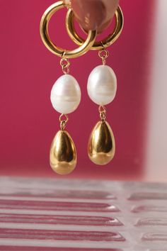 Get ready for some serious sparkle with these golden dangling earrings featuring freshwater pearls Product Details Size: 5 cm length / .8 cm width 18K Gold Plated Stainless Steel Water-Resistant HypoallergenicDurable Dangling Earrings, Steel Water, Ring Necklace, Fresh Water, Freshwater Pearls, Dangle Earrings, 18k Gold, Gold Plate, Plating