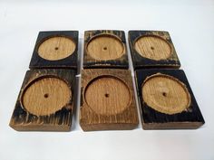 four wooden coasters with holes in them on a white table top, set of 4